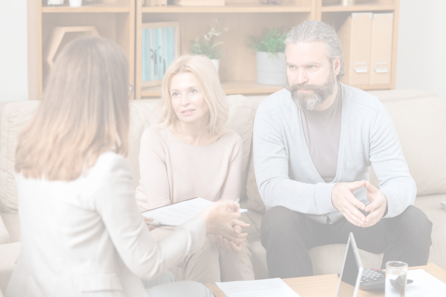 Lawyer sitting with couple in living room