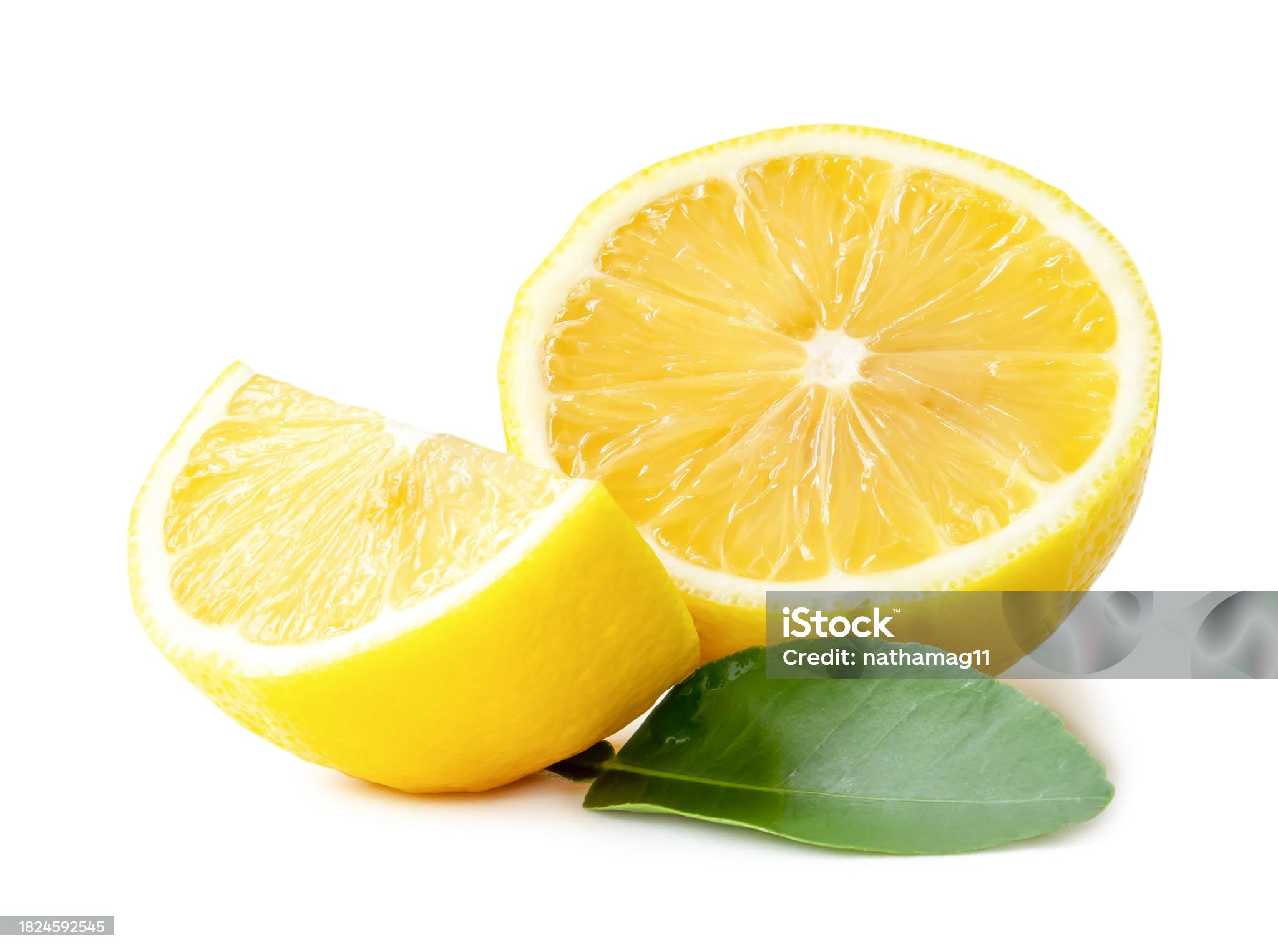Fresh yellow lemon half with quarter and leaves is isolated on white background with clipping path.