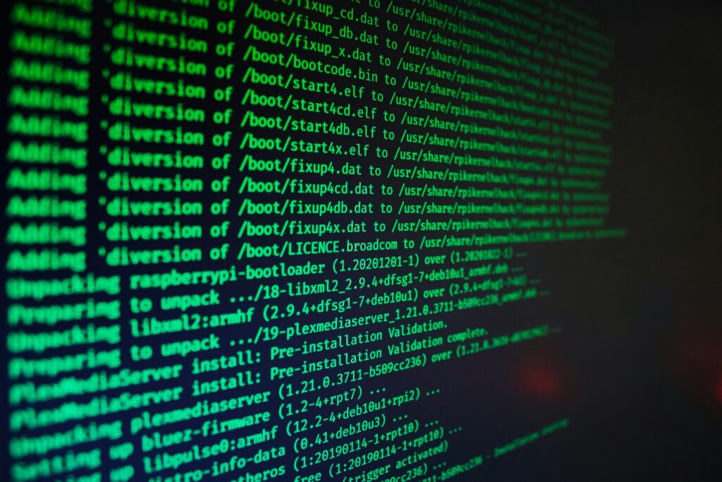Close-up of a dark screen with bright green code lines, resembling a terminal or console output.