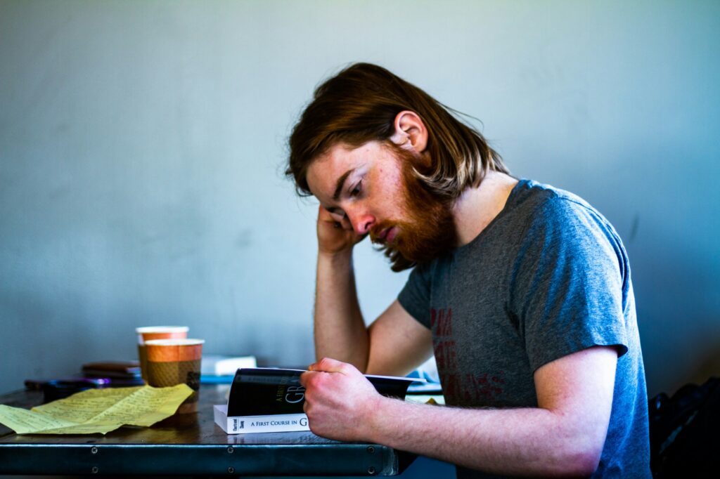 a college student studying at a coffee shop