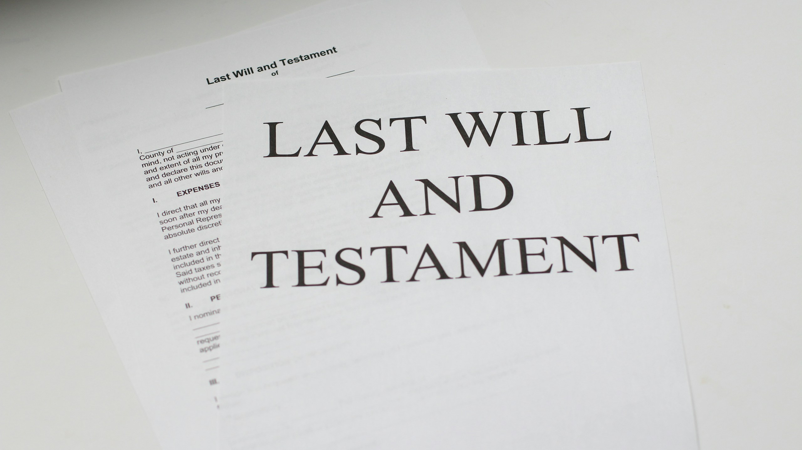 Close-up of a legal document with the words LAST WILL AND TESTAMENT in large type on white paper. (Informative image)