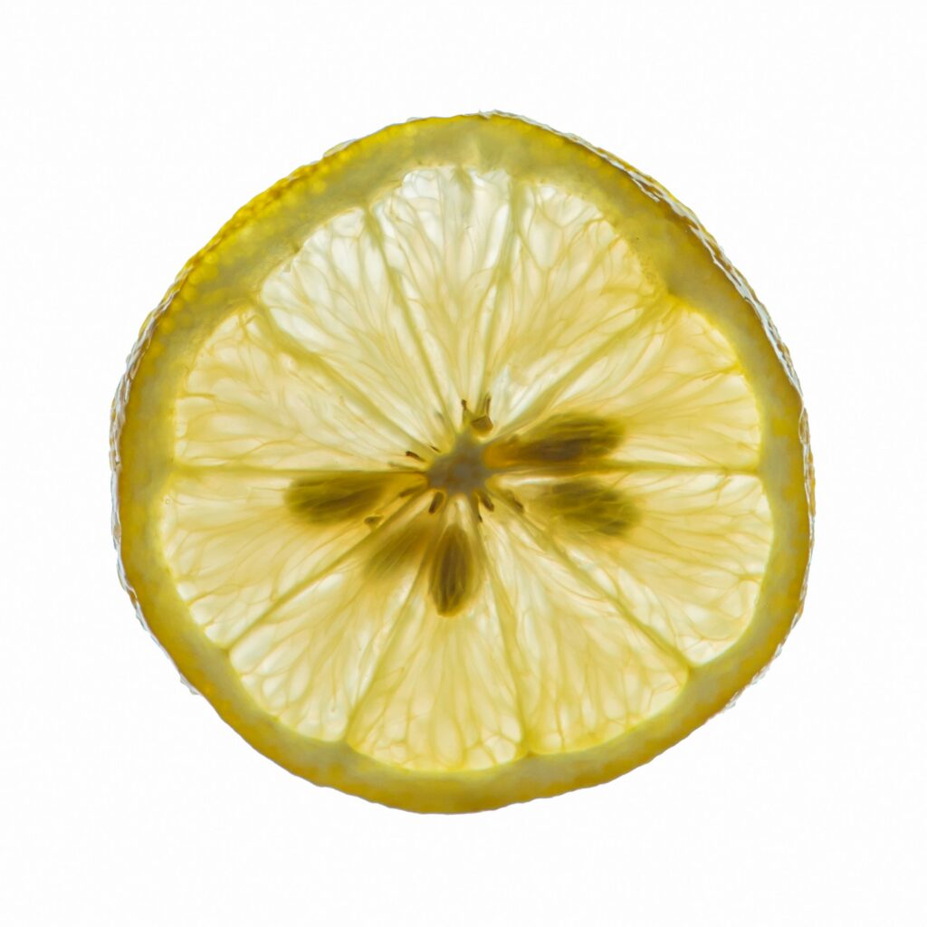 Close-up of a lemon slice against a white background, showing yellow rind and translucent pulp.