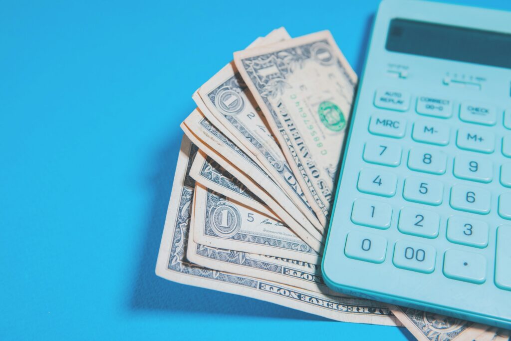 calculator and one hundred dollar banknote. t